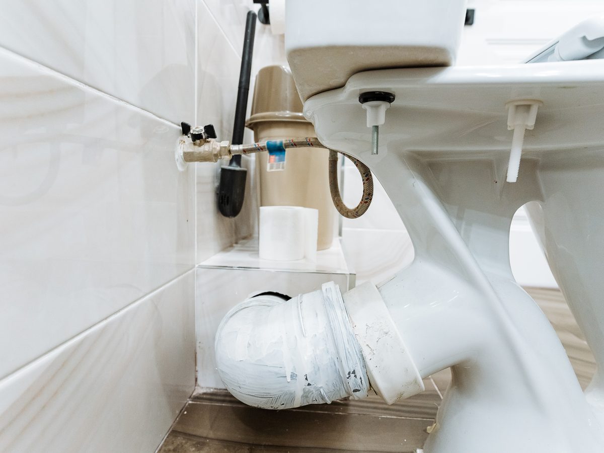 PVC waste pipework visible beneath a toilet pan